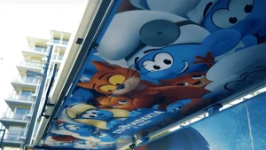 politis smurfs outdoor advertising ooh wrap shelter